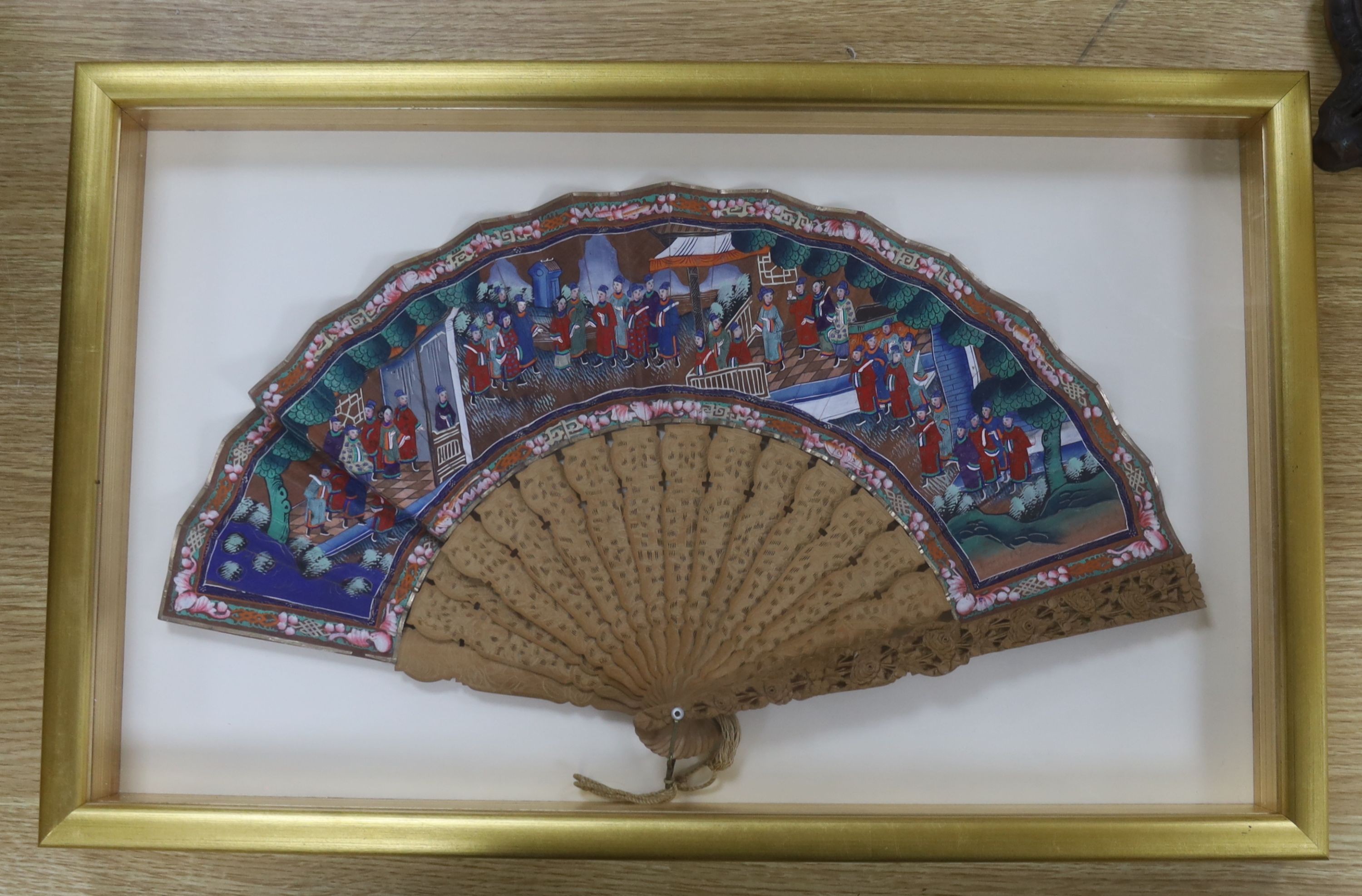Two Chinese export painted leaf fans, 19th century, one with carved sandalwood guards and sticks, the other with black lacquer, largest case 39 x 63cm